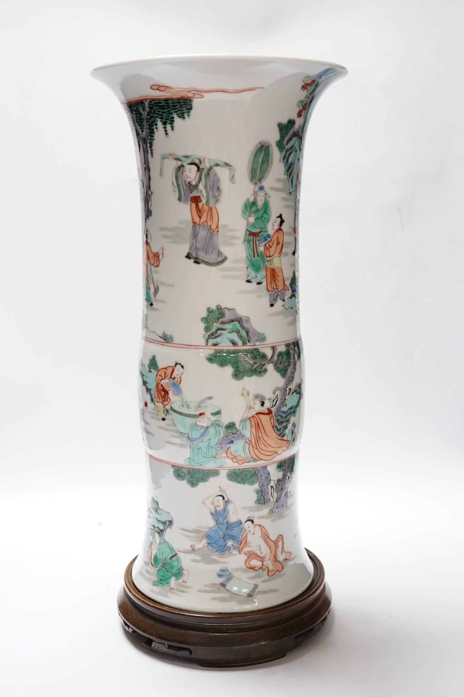 A Chinese famille verte beaker vase, Kangxi mark but later, on hardwood stand, 46cm total height